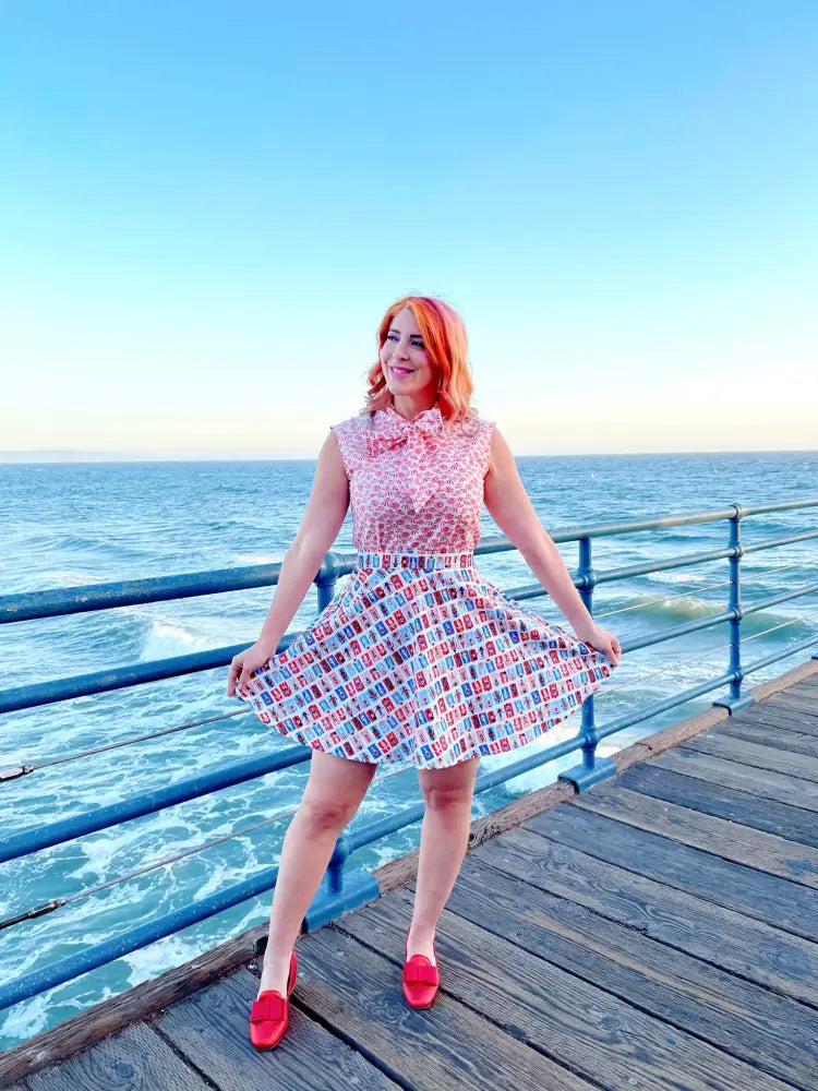 Pink and white patterned sleeveless top with bow neckline paired with sunny days vintage phone print skater skirt