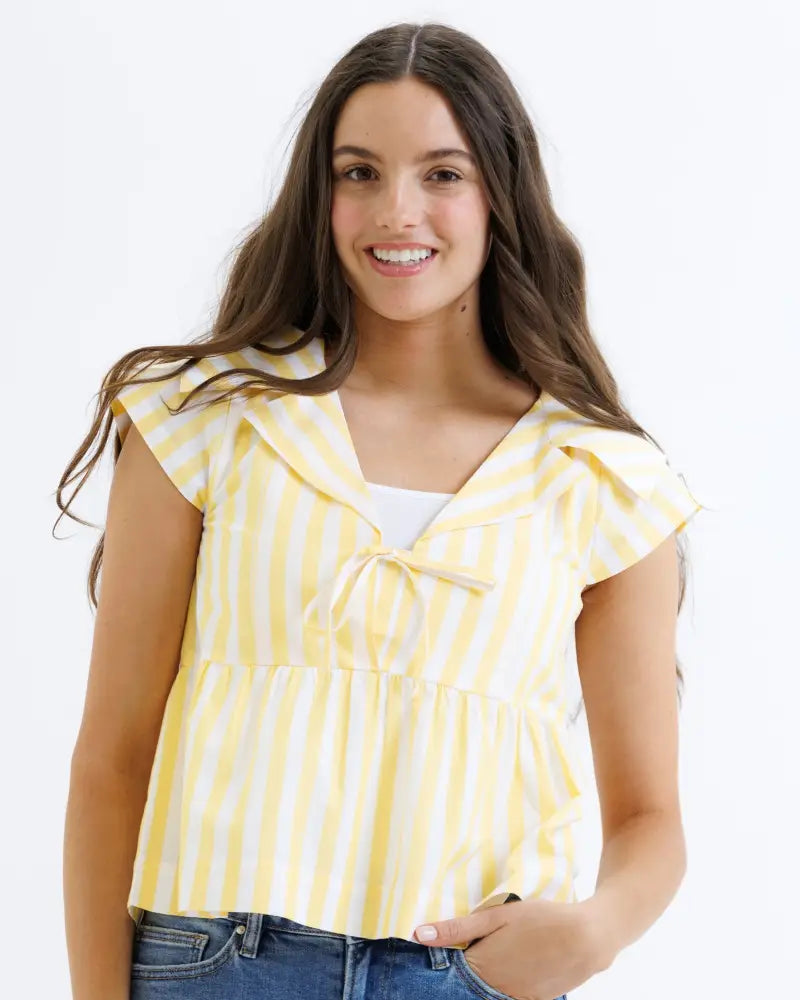 Yellow and white striped cotton peplum blouse with short sleeves ruffled collar and tie front detail