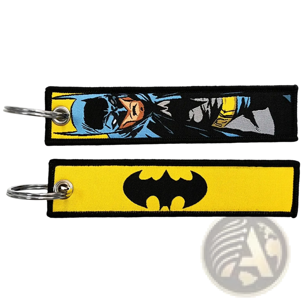 Two superhero embroidered keychains featuring a blue and yellow comic-style batman design and a black bat symbol on yellow fabric