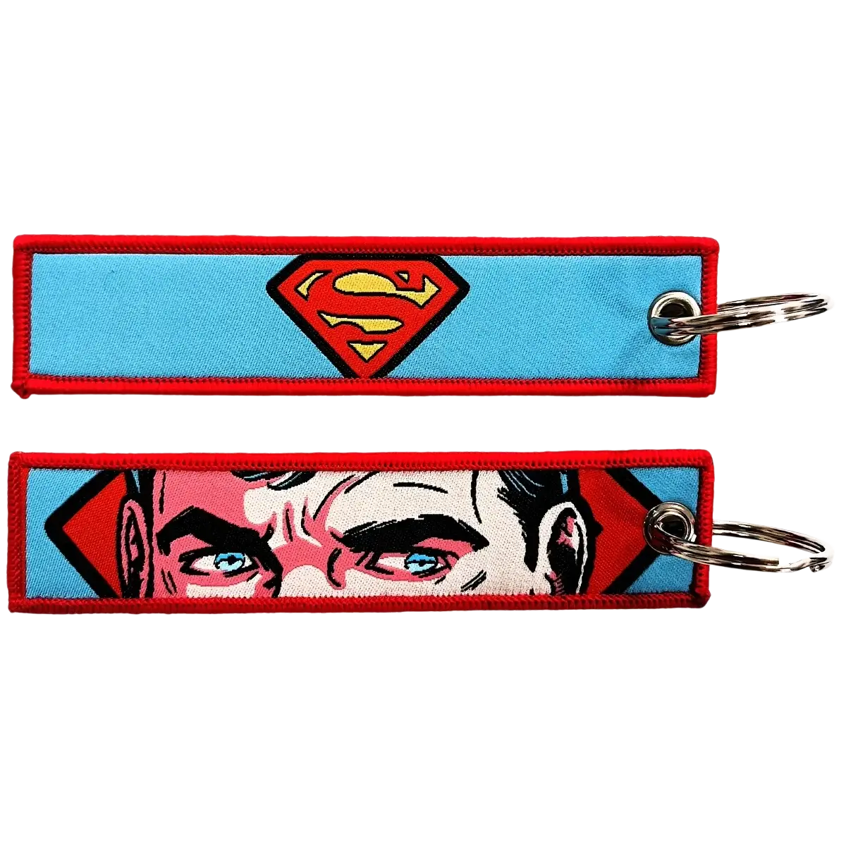 Two embroidered superhero keychains with superman logo on blue and clark kent face in comic style for anime key lanyard
