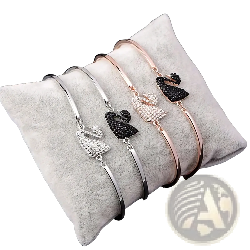 Three elegant swan crystal charm bangle bracelets in silver, rose gold, and black with rhinestone accents