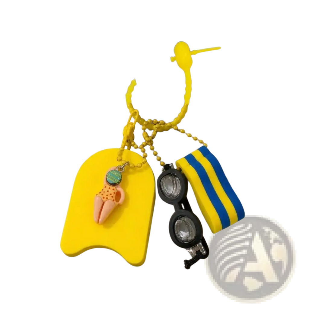 Bright yellow silicone swimming keychain miniature kickboard bag charm with a pink and orange polka-dot swimsuit charm attached