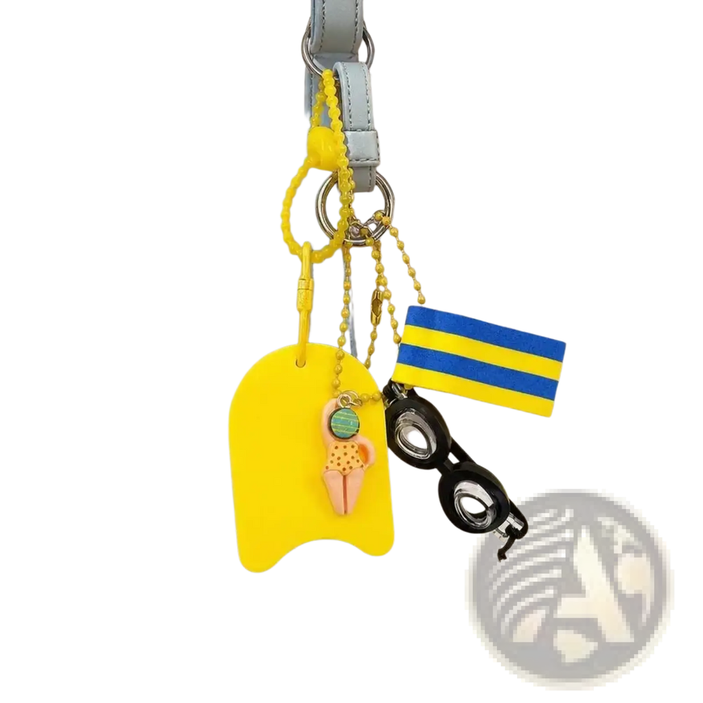 Bright yellow silicone swimmer-shaped mini kickboard keychain with blue and yellow striped flag bag charm