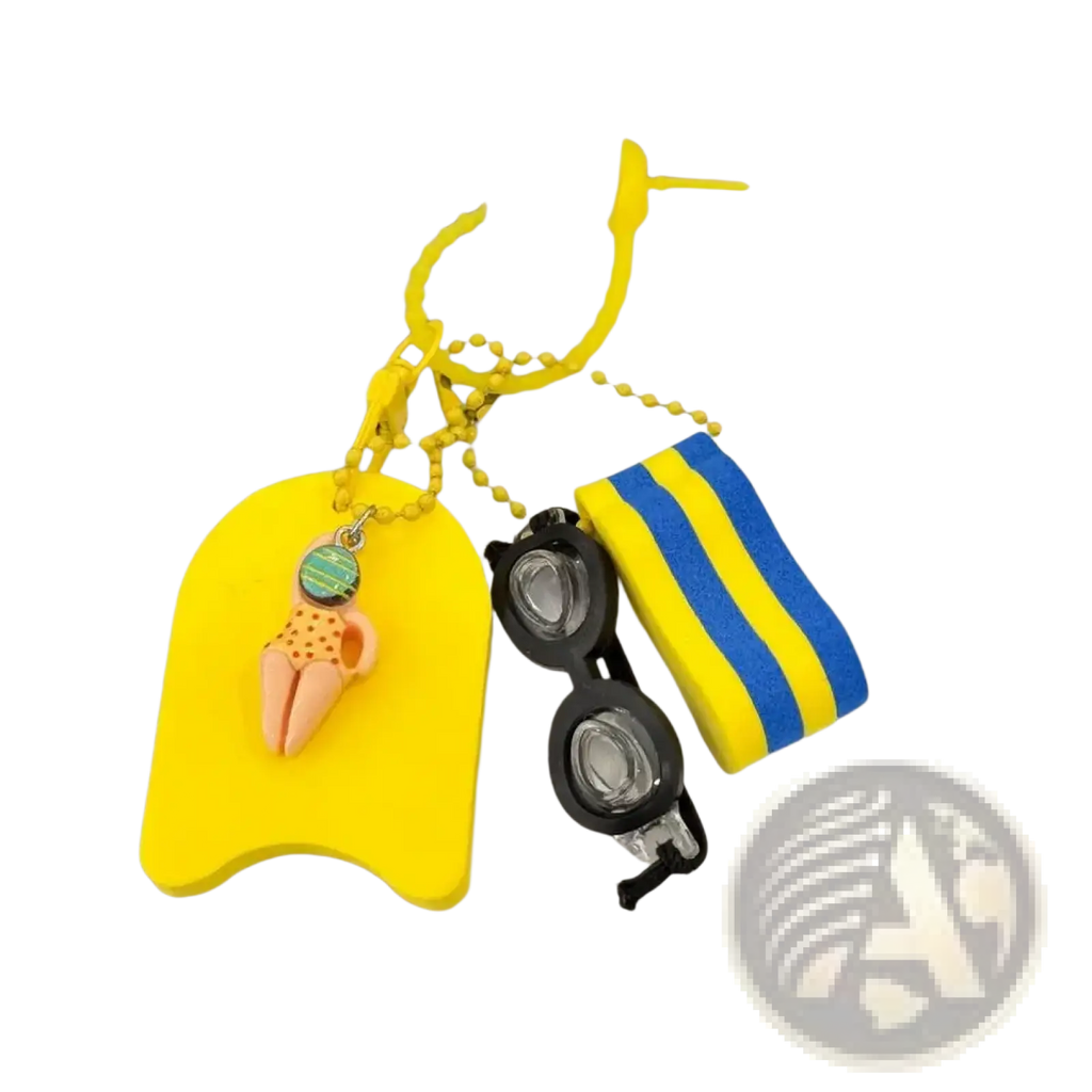 Bright yellow foam swim float keychain with small orange figurine in swimwear hanging from tote bag charm