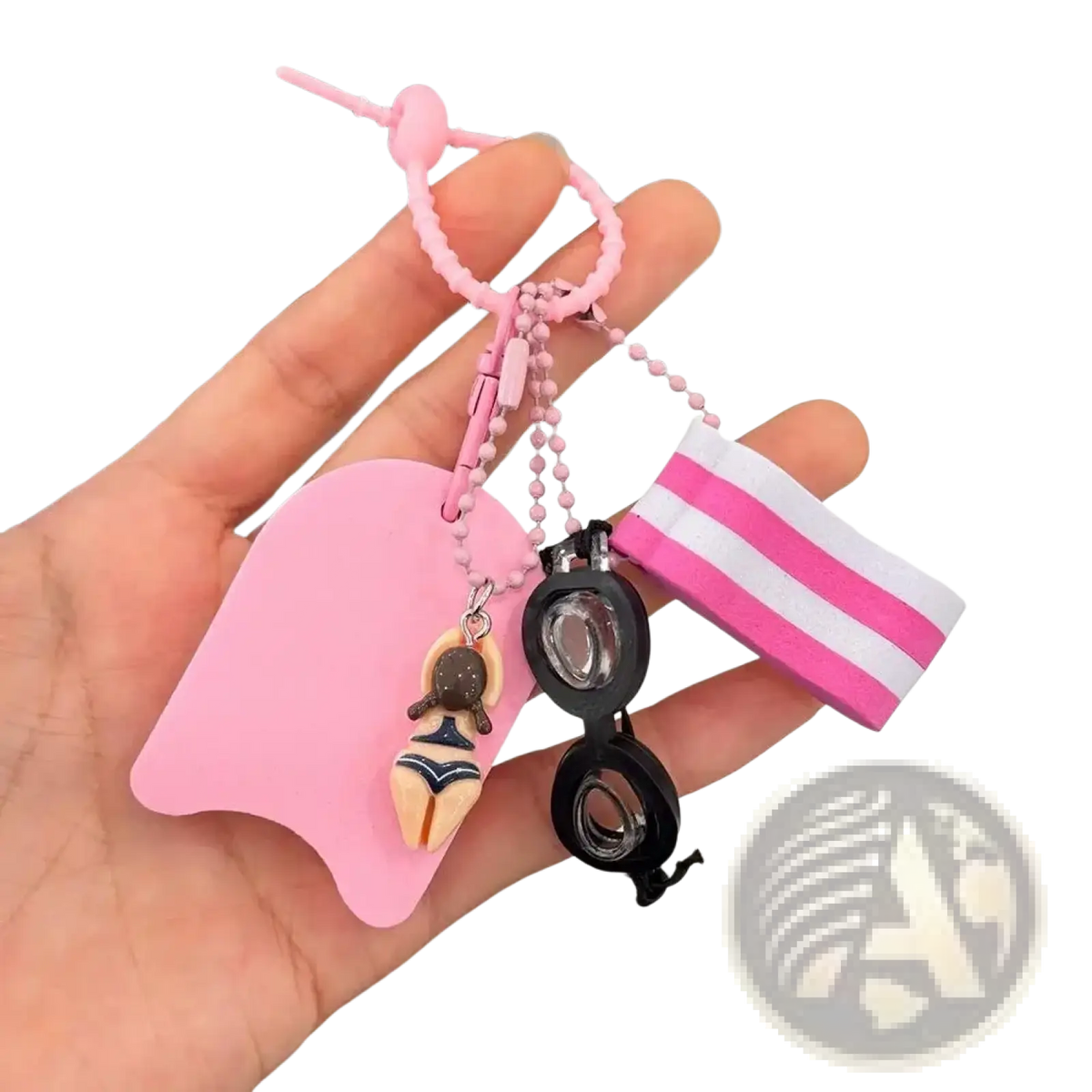 Pink silicone swimming keychain featuring a miniature swimsuit figurine, black goggles charm, and striped buoyant accessory