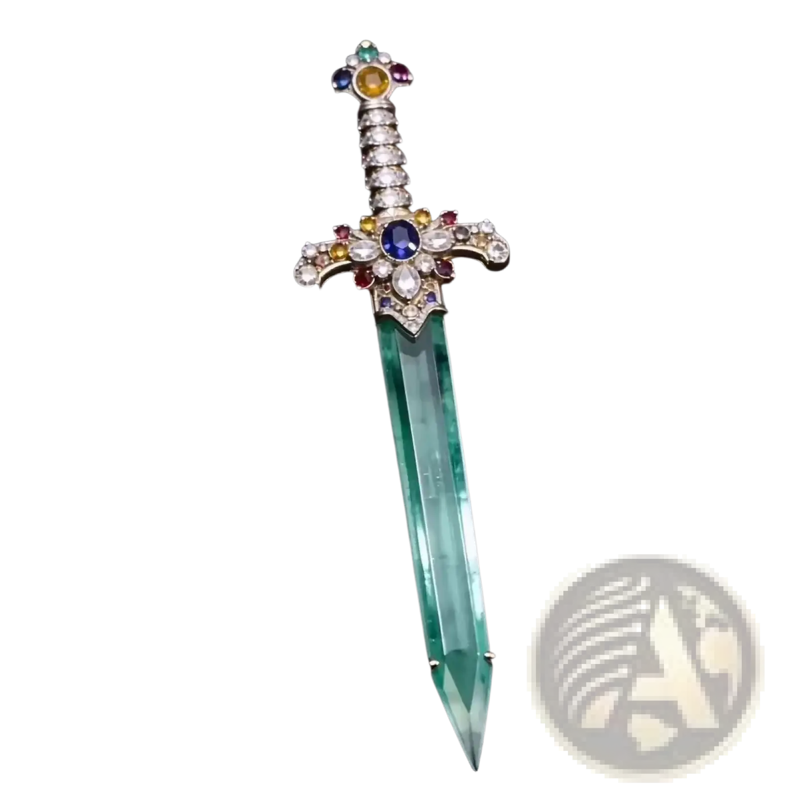 A sword brooch featuring a translucent green crystal blade and an ornate hilt adorned with multicolored gemstones