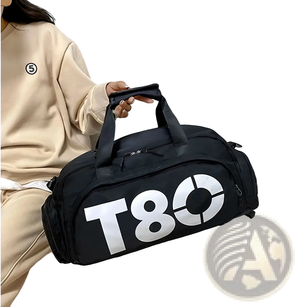 Black t80 gym duffel bag with shoe compartment featuring bold white lettering and dual top handles for easy carrying