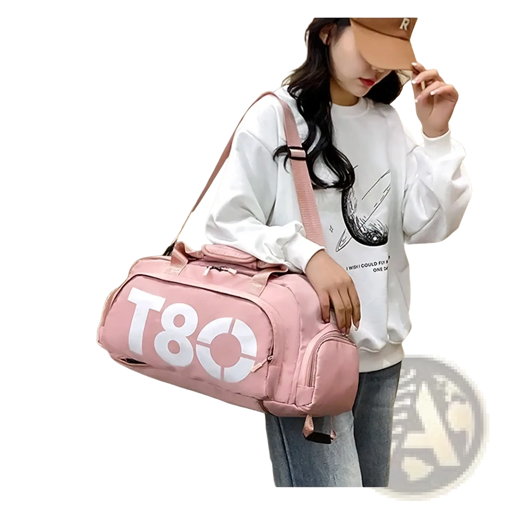 Pink t80 gym duffel bag with white lettering and matching shoulder strap featuring a shoe compartment