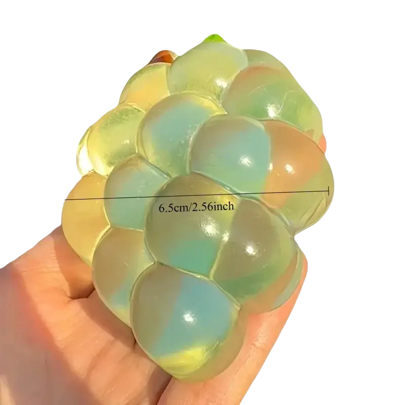 A translucent iridescent grape-shaped stress ball with gradient green yellow and orange hues for taba-licious fun fruit