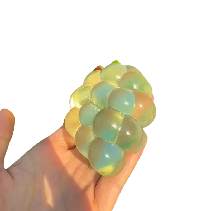 A translucent multicolored grape-shaped stress ball with glossy finish from taba-licious fun fruit fidget toy collection
