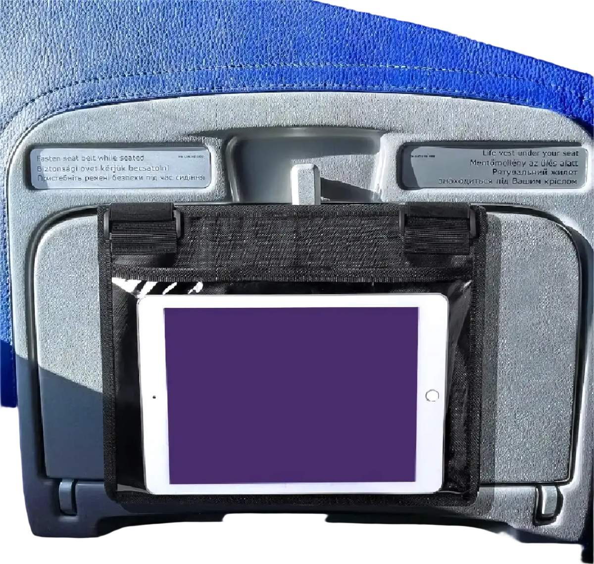 Black fabric tablet holder securely gripping a white iPad on an airplane seat for travel convenience