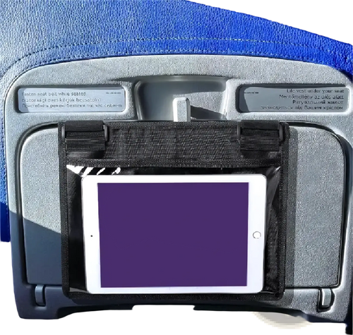 Black fabric tablet holder securely gripping a white iPad on an airplane seat for travel convenience