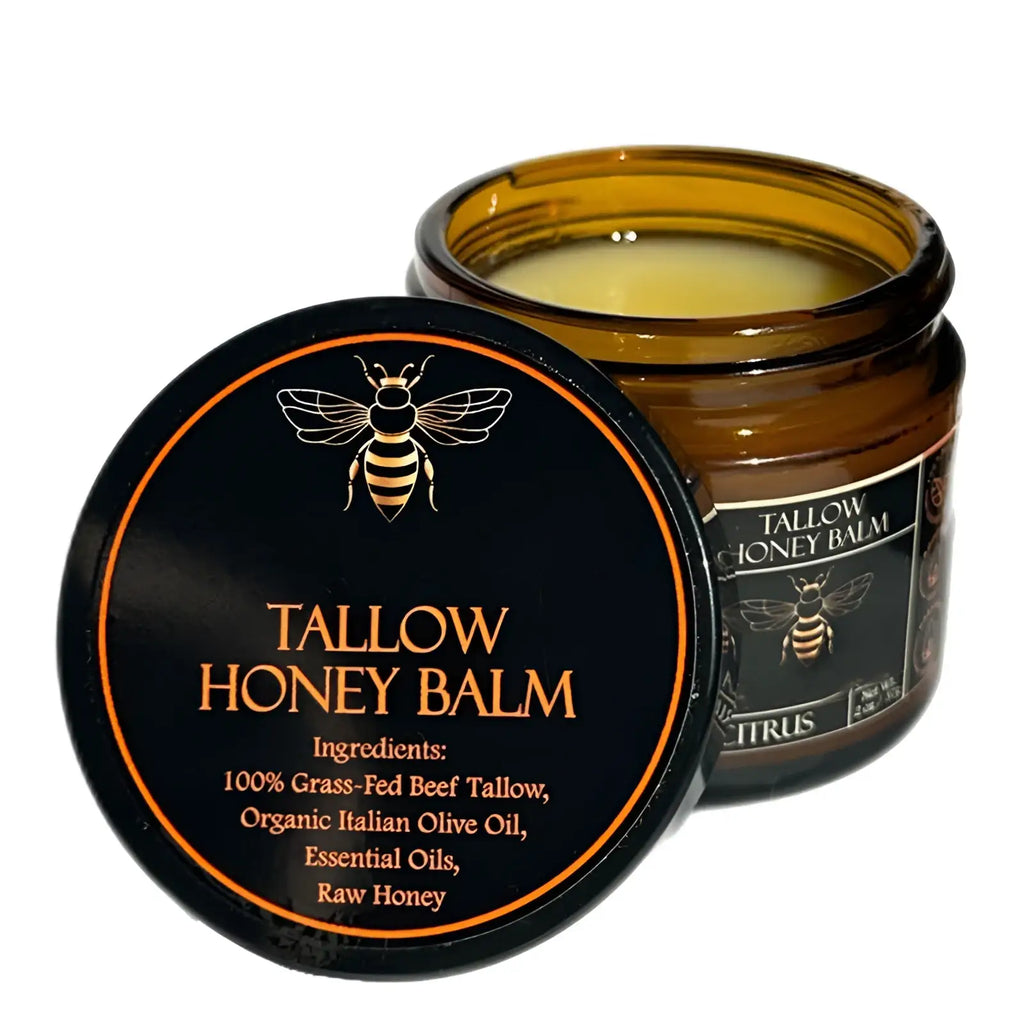 A sleek amber glass jar with black lid containing creamy yellow tallow honey balm moisturizing body cream 100g