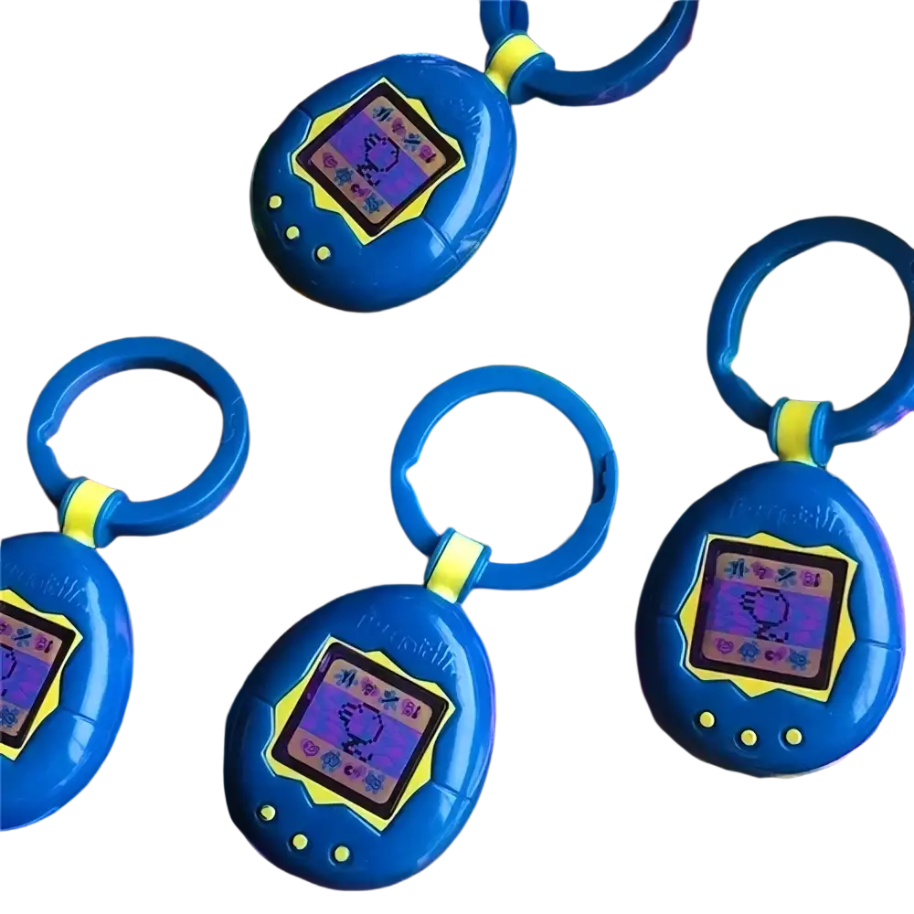 Blue plastic tamagotchi electronic virtual pet keychain with yellow screen accent and three buttons below from 90s toy collection
