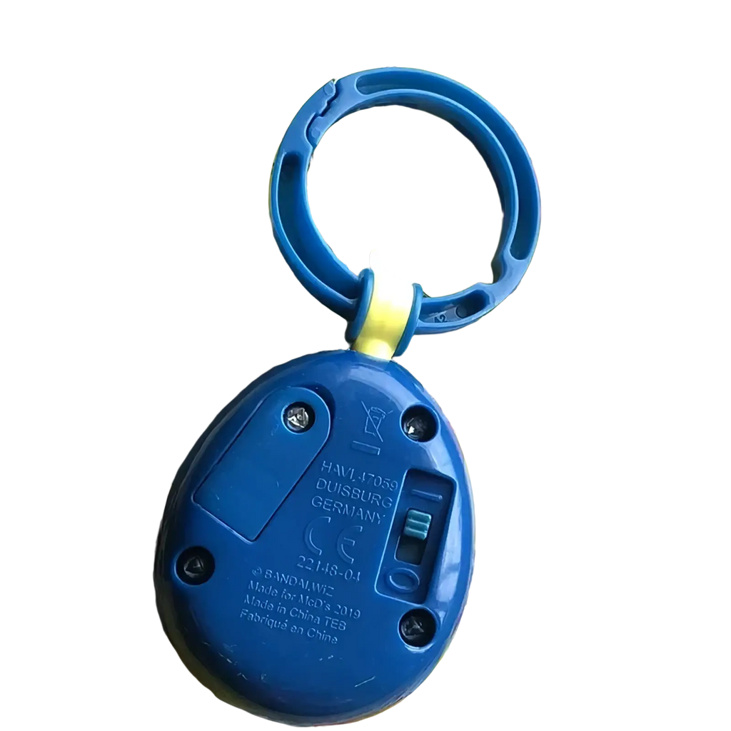 Blue plastic tamagotchi electronic virtual pet keychain with circular handle featuring bandai med 2019 text on back