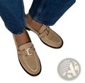 Tan suede horsebit loafers with round toe, flat heel, gold-tone buckle, and black rubber soles