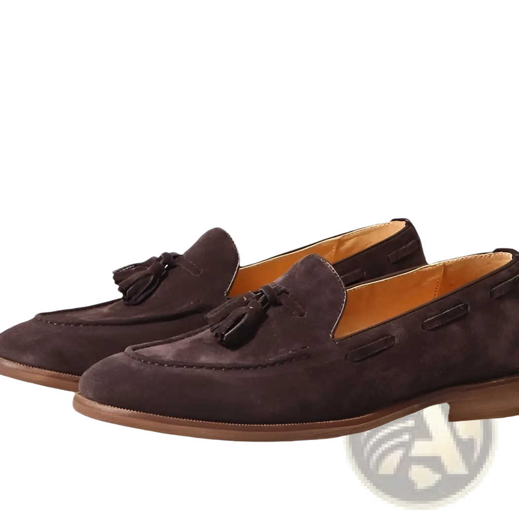 Tan suede tassel loafers in brown with black tassels and tan leather lining featuring stitched rubber sole