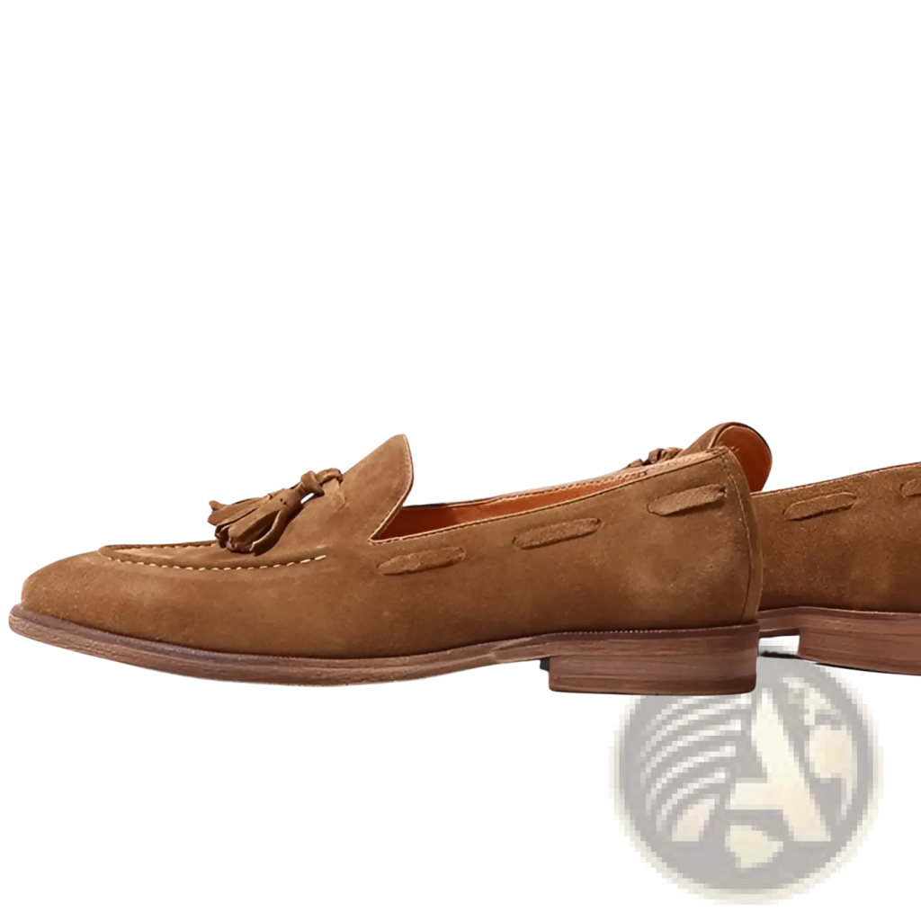 Tan suede tassel loafers with stitched rubber sole featuring decorative tassel detail on the vamp