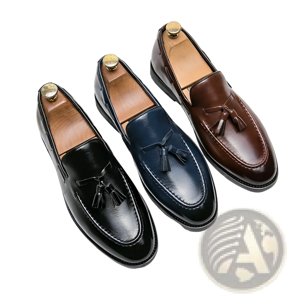 Three pairs of polished leather tassel loafers in black navy blue and brown slip on shoes for formal wear