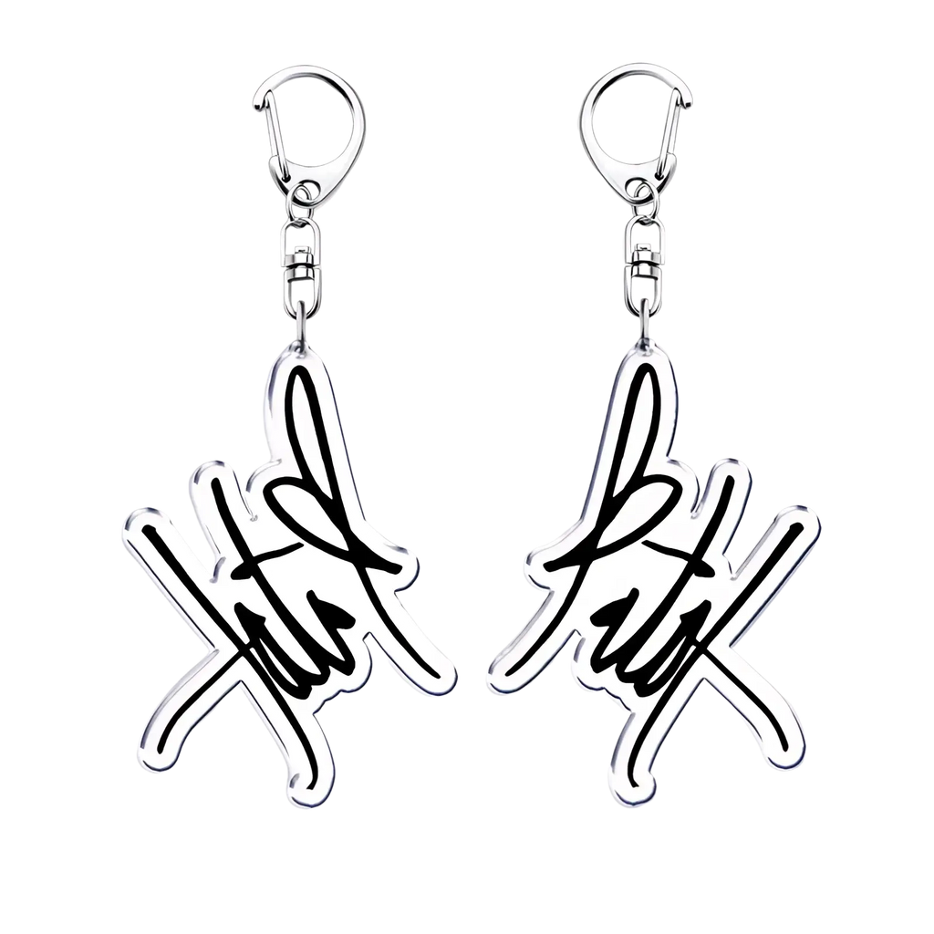 Silver acrylic Tate Mcrae keychain with stylized signature design and black ink detailing for music fan gift