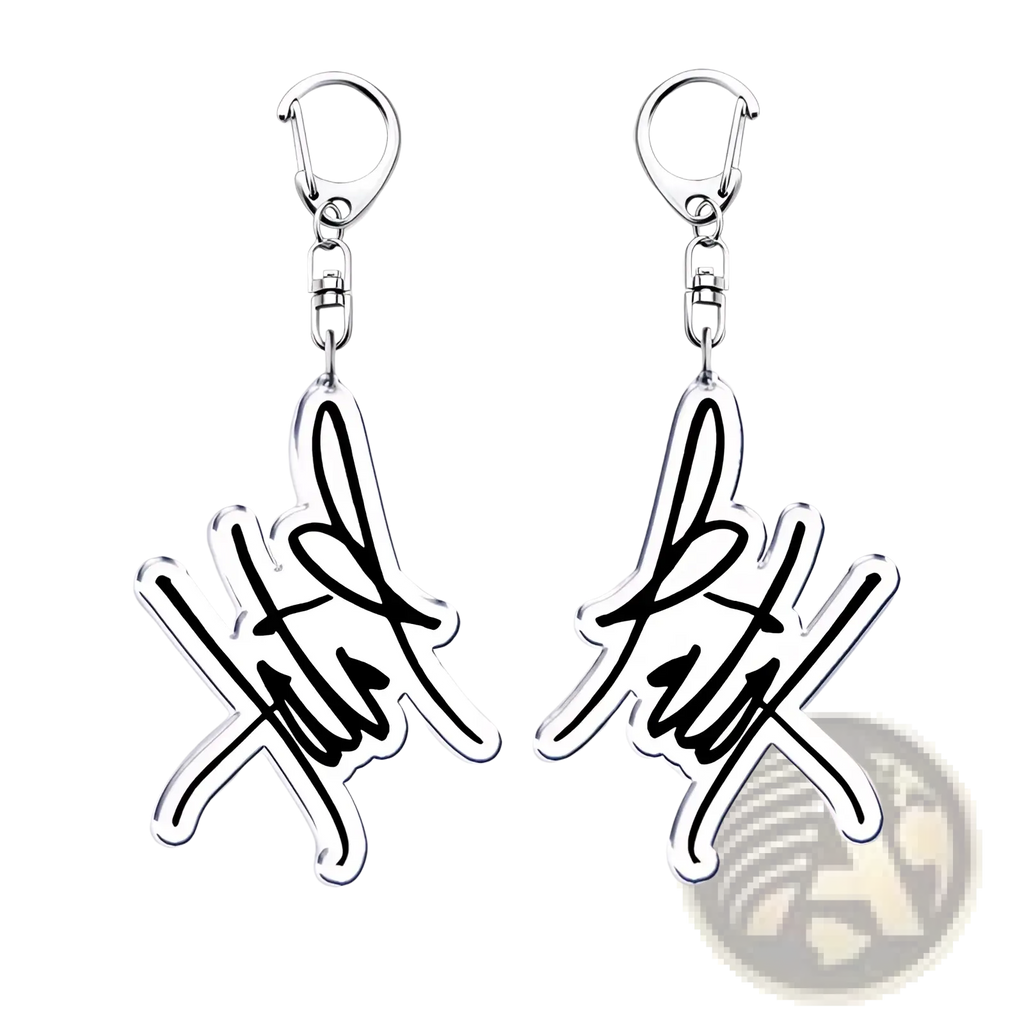 Silver acrylic Tate Mcrae keychain with stylized signature design and black ink detailing for music fan gift