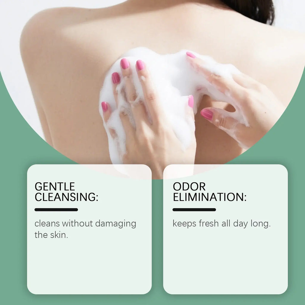 A creamy white foaming tea tree body wash moisturizing skin cleanser lathered onto skin by hands with pink nail polish