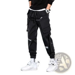 Black mens tactical cargo pants with multiple pockets drawstring waistband and white text on leg for streetwear