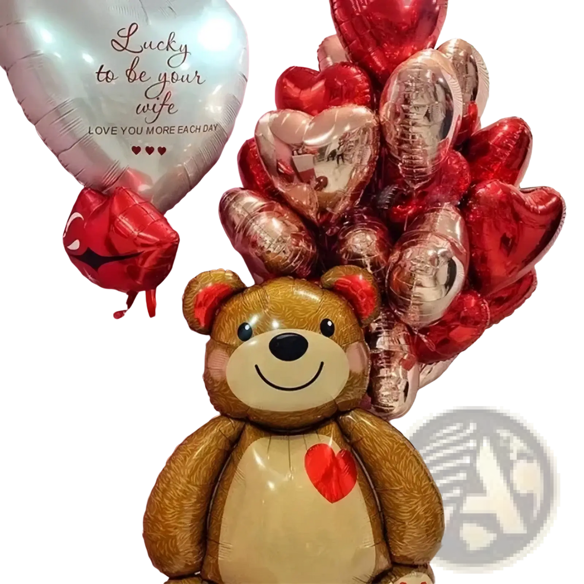 A brown inflatable teddy bear foil balloon with a red heart and black eyes surrounded by red and rose gold heart balloons