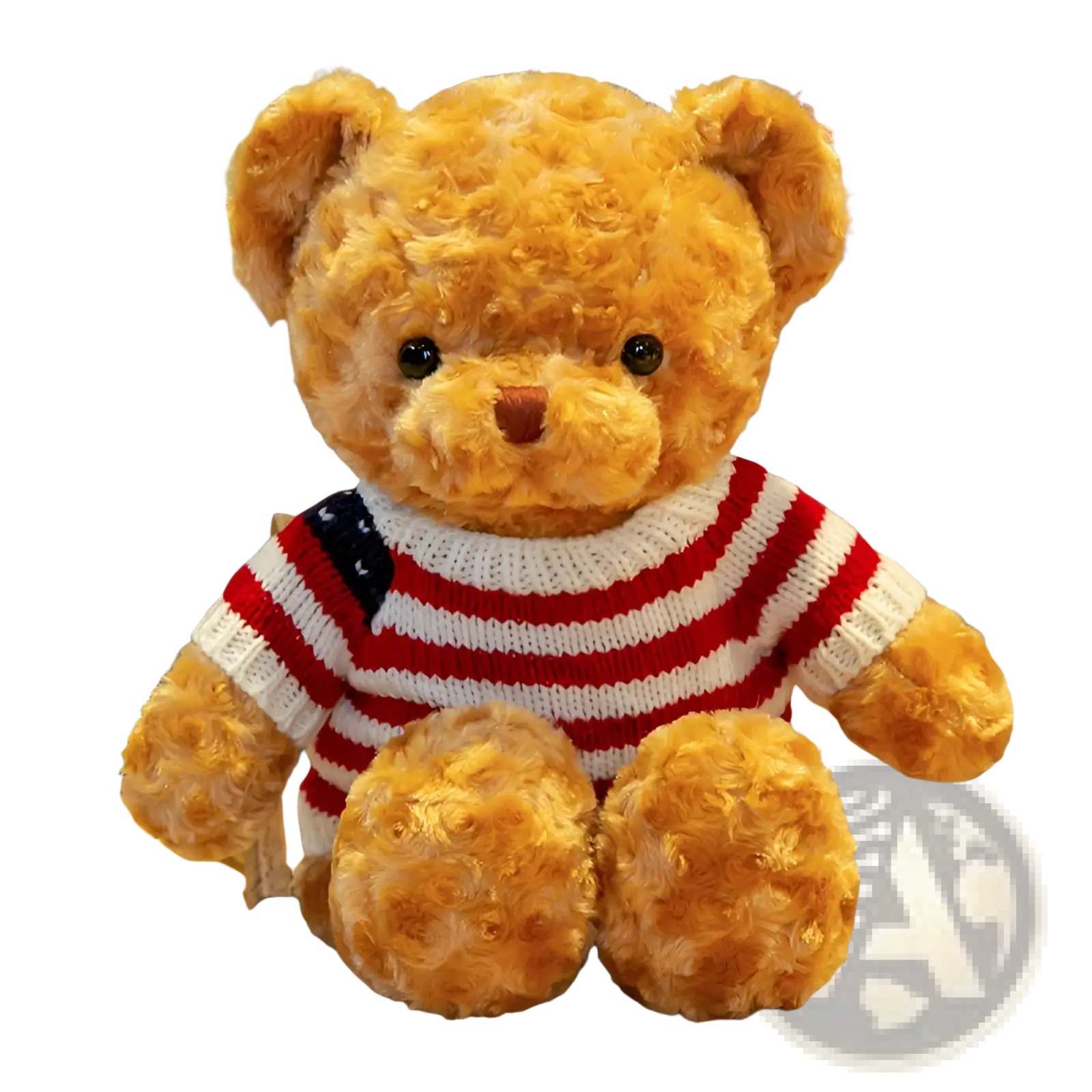 A plush golden-brown teddy bear wearing a red and white striped knit sweater with an American flag patch