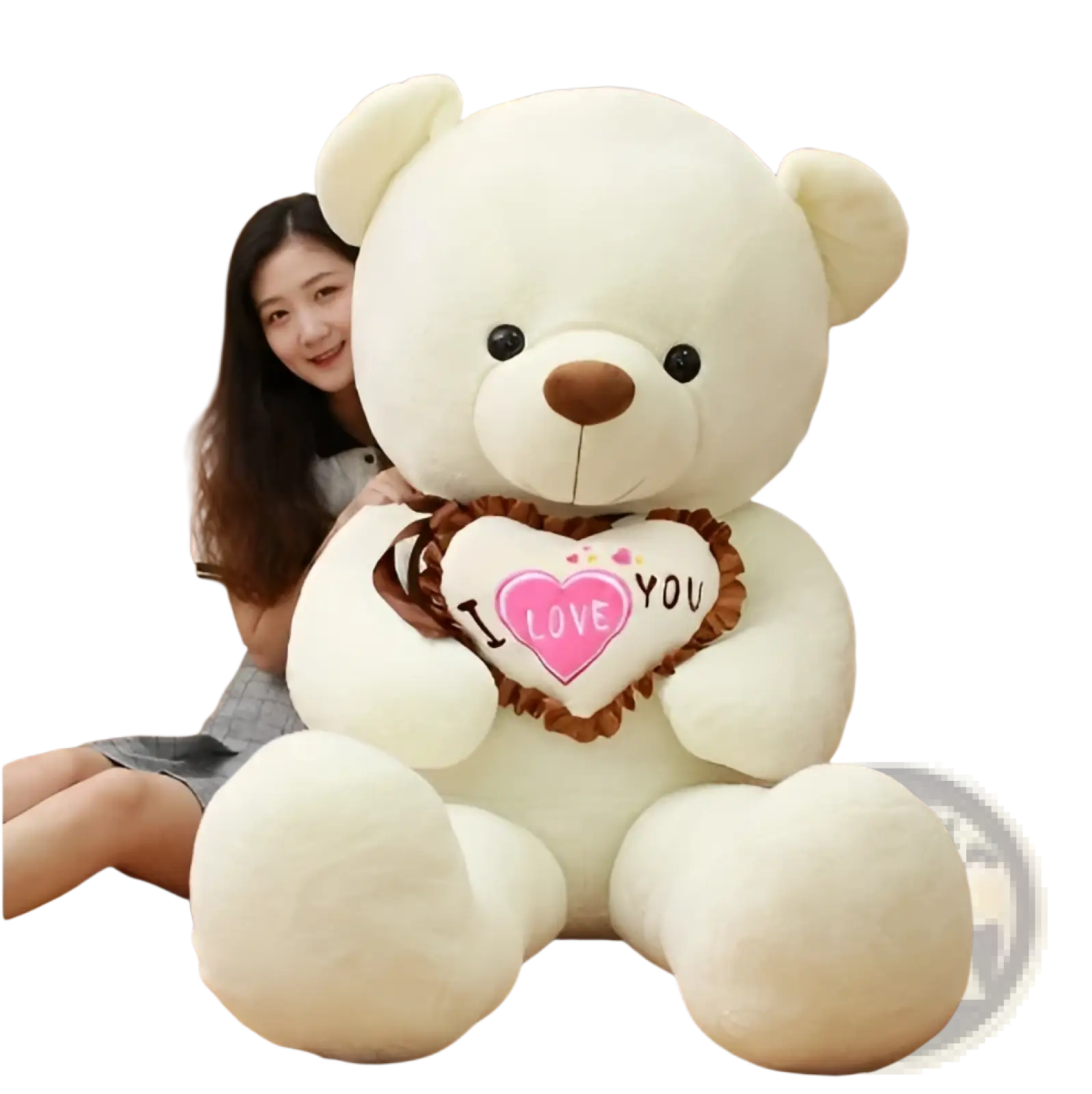 Cream-colored plush teddy bear soft stuffed animal holding a heart-shaped pillow with i love you text and pink hearts