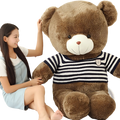 A plush brown teddy bear wearing a navy and white striped knit sweater with an embroidered chest patch
