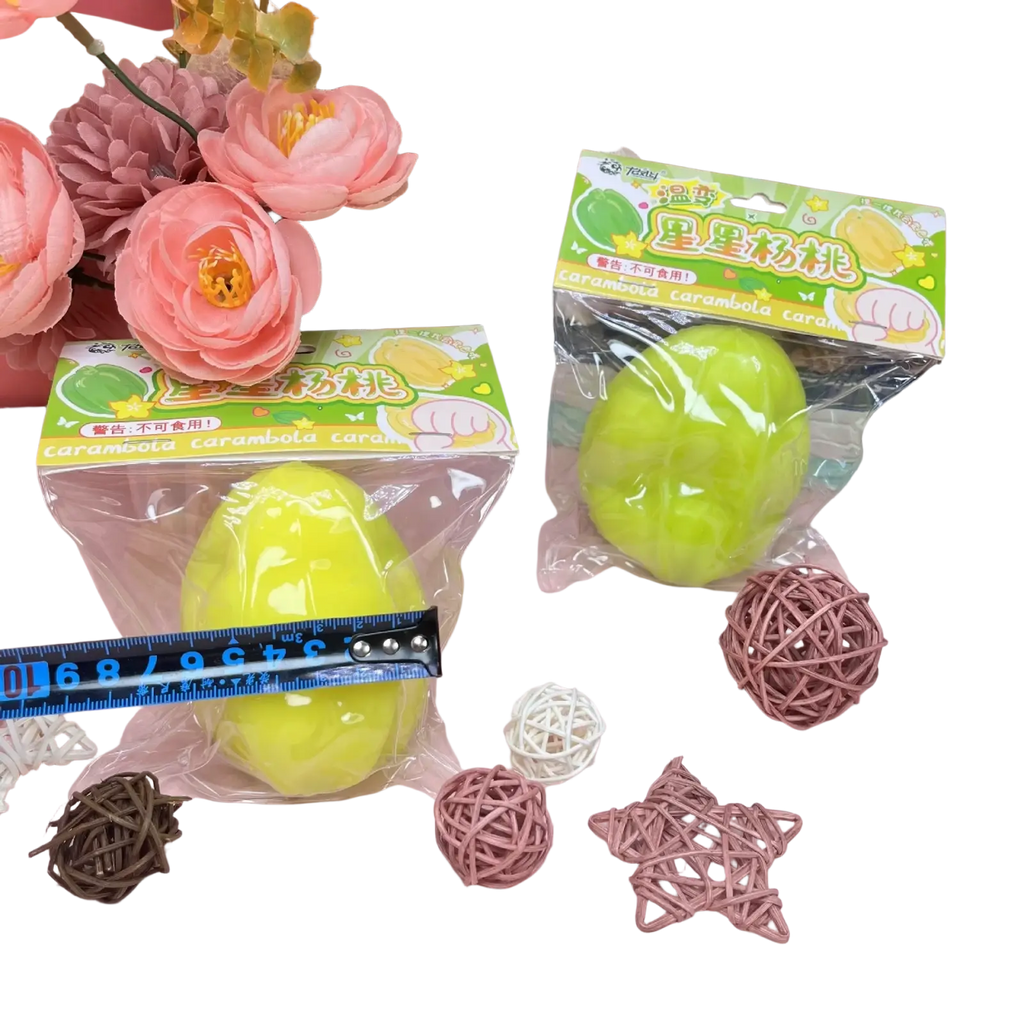 Bright lime-green temperature changing star fruit squishy toy made of glossy material in clear plastic packaging with colorful label