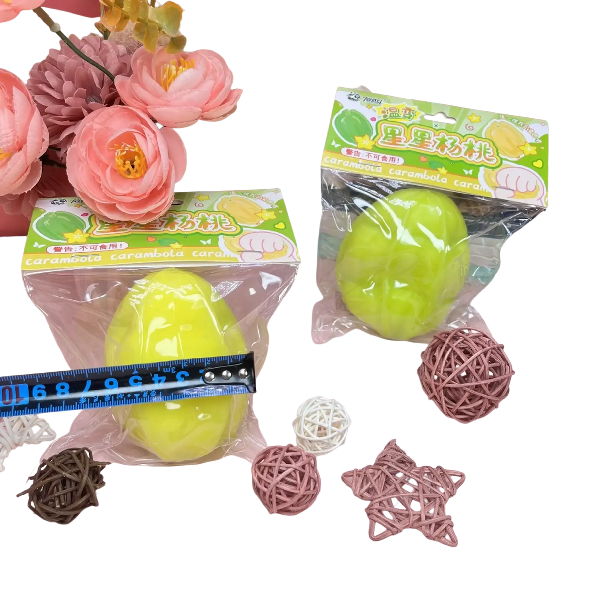 Bright lime-green temperature changing star fruit squishy toy made of glossy material in clear plastic packaging with colorful label