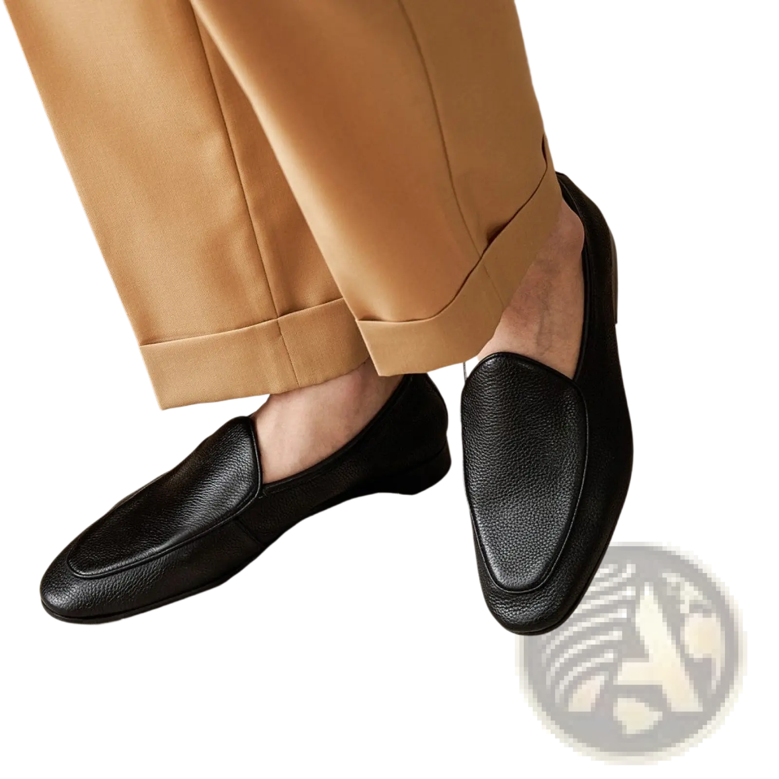 Black leather loafers with textured cowhide surface and classic pointed toe slip-on design