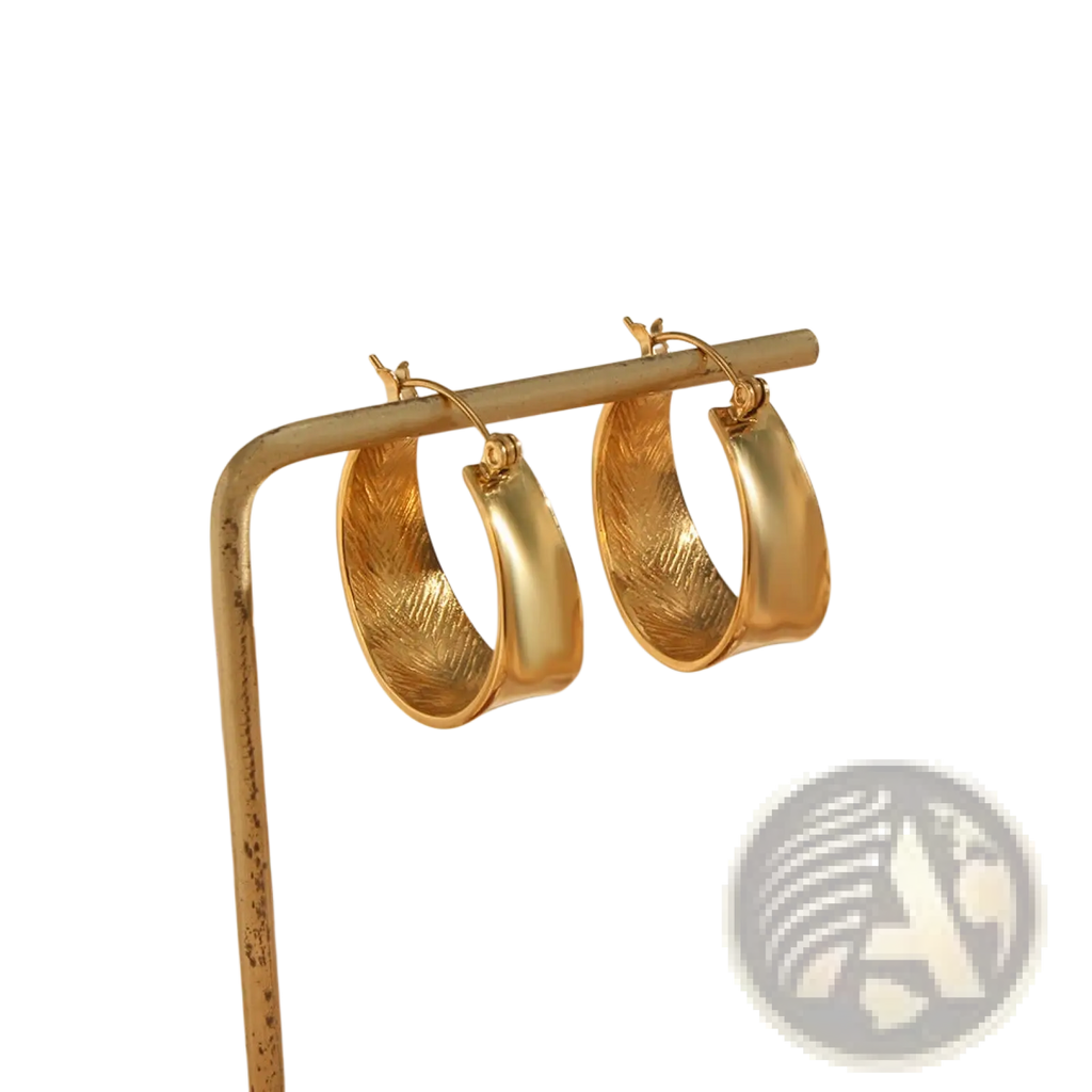 Textured feather interior gold gradient hoop earrings with smooth outer edges showcasing detailed feather pattern