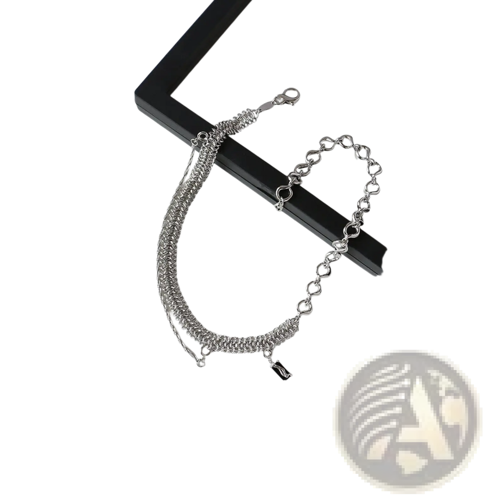 Textured heart link silver bracelet with mixed textured and heart-shaped links featuring a small black charm