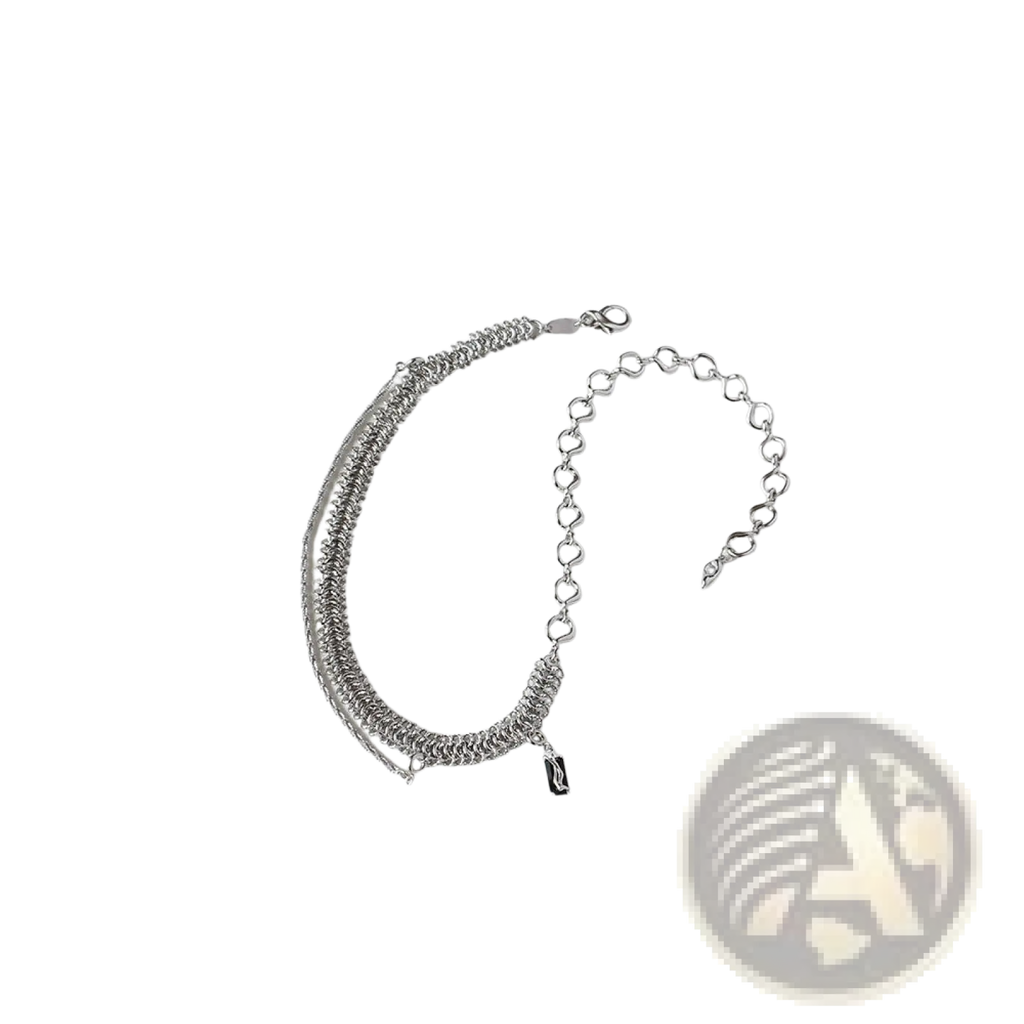 Silver chain bracelet with layered textured heart links and a small black charm in sterling silver