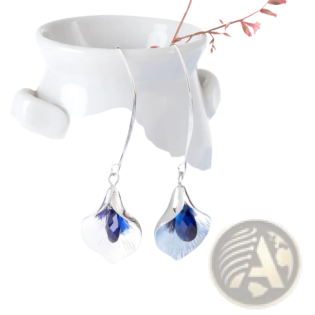 Textured silver orchid crystal drop earrings with delicate leaf-shaped design and central deep blue crystal accent