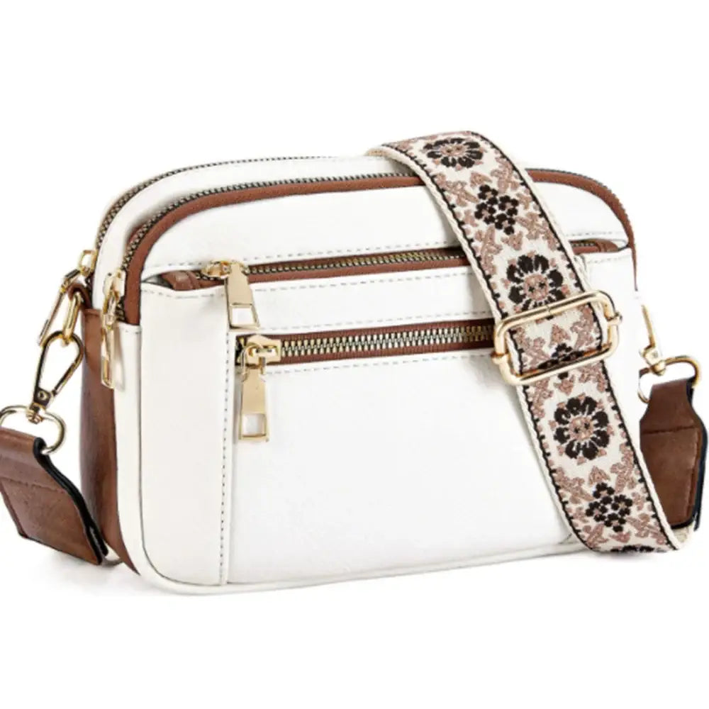 Juniper white and brown crossbody bag with floral-patterned strap designed for stylish everyday use