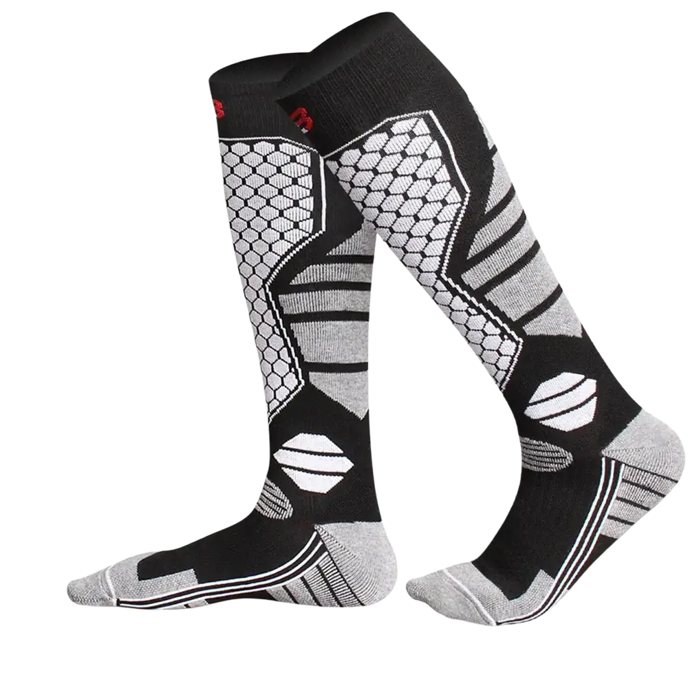 Thermal knee high ski socks in black and gray feature geometric hexagons stripes and white accents for warmth