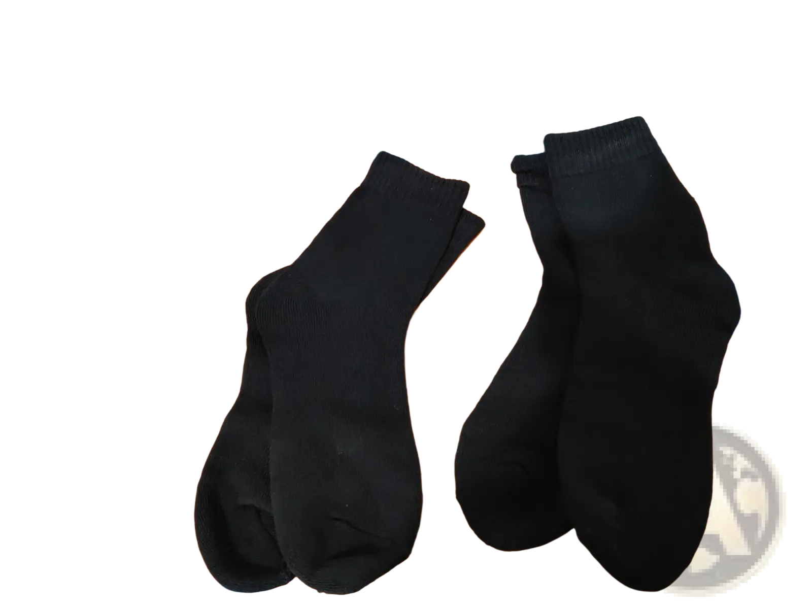 A pair of black plain-knit thermal winter socks on an orange surface designed for cold protection unisex use
