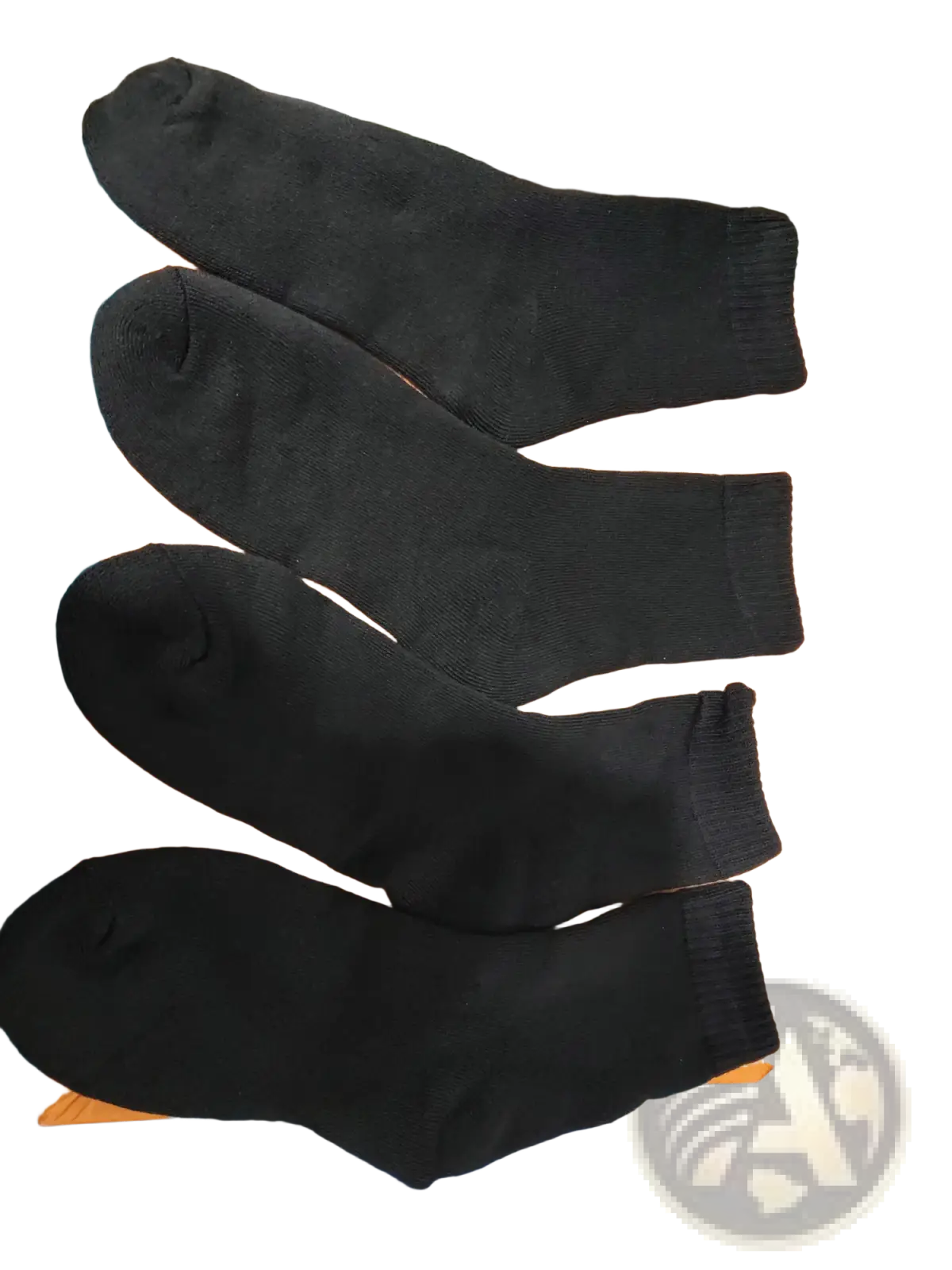 Four black thermal winter crew socks arranged on an orange surface for unisex cold protection use