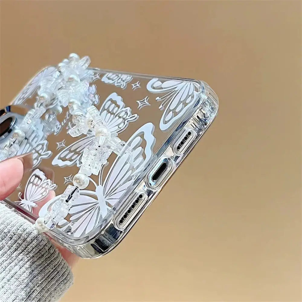 Back side of clear butterfly mirror iphone 15 pro max protective case with white decals and dangling bead charm