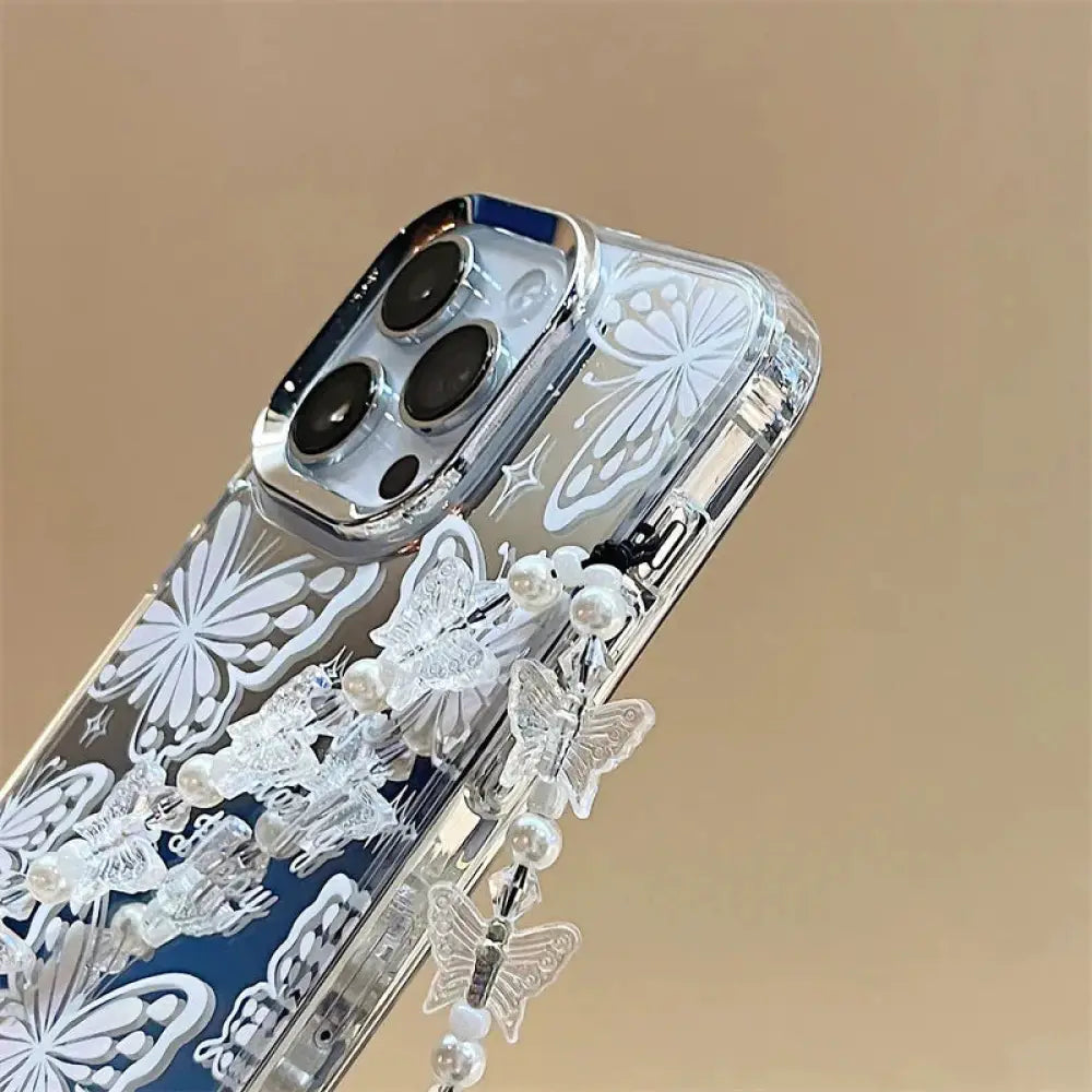 Back side of clear butterfly mirror iphone 15 pro max case with white decals and dangling pearl-adorned butterflies