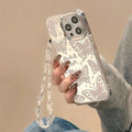 Clear butterfly mirror iphone 15 pro max protective case with silver butterfly star patterns and matching crystal chain strap back view