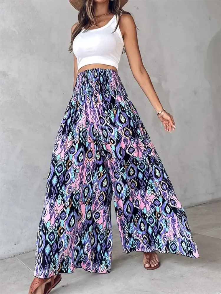 Tie dye wide leg pants featuring vibrant geometric patterns in shades of purple pink and blue with a loose fit