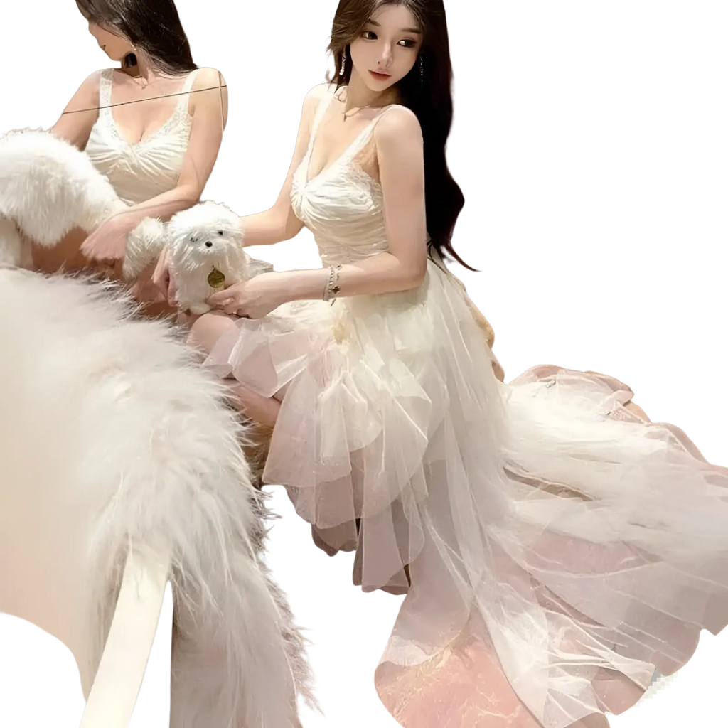 A flowing off-white tiered tulle and lace mesh evening gown with delicate spaghetti straps and a fitted bodice