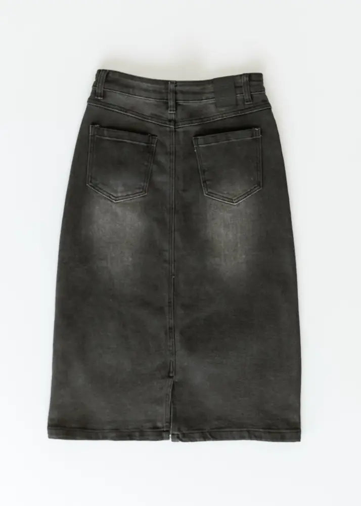 Black denim midi skirt with high waist button front and straight cut shown from the back with two pockets