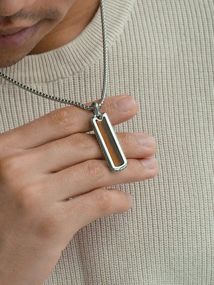 Silver-toned stainless steel rectangular pendant necklace with warm amber tiger eye inlay on a fine chain