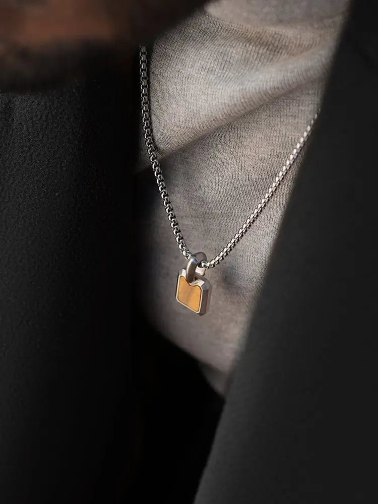 Silver chain tiger eye inset stainless steel dog tag necklace with rectangular gold toned lock pendant